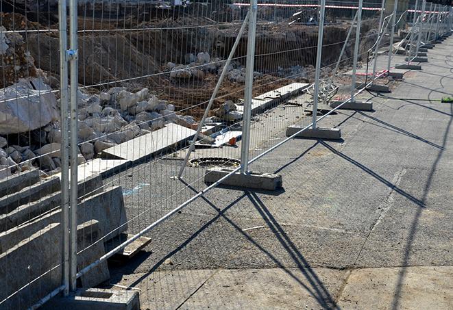 temporary fence panels lining a construction site for safety and security